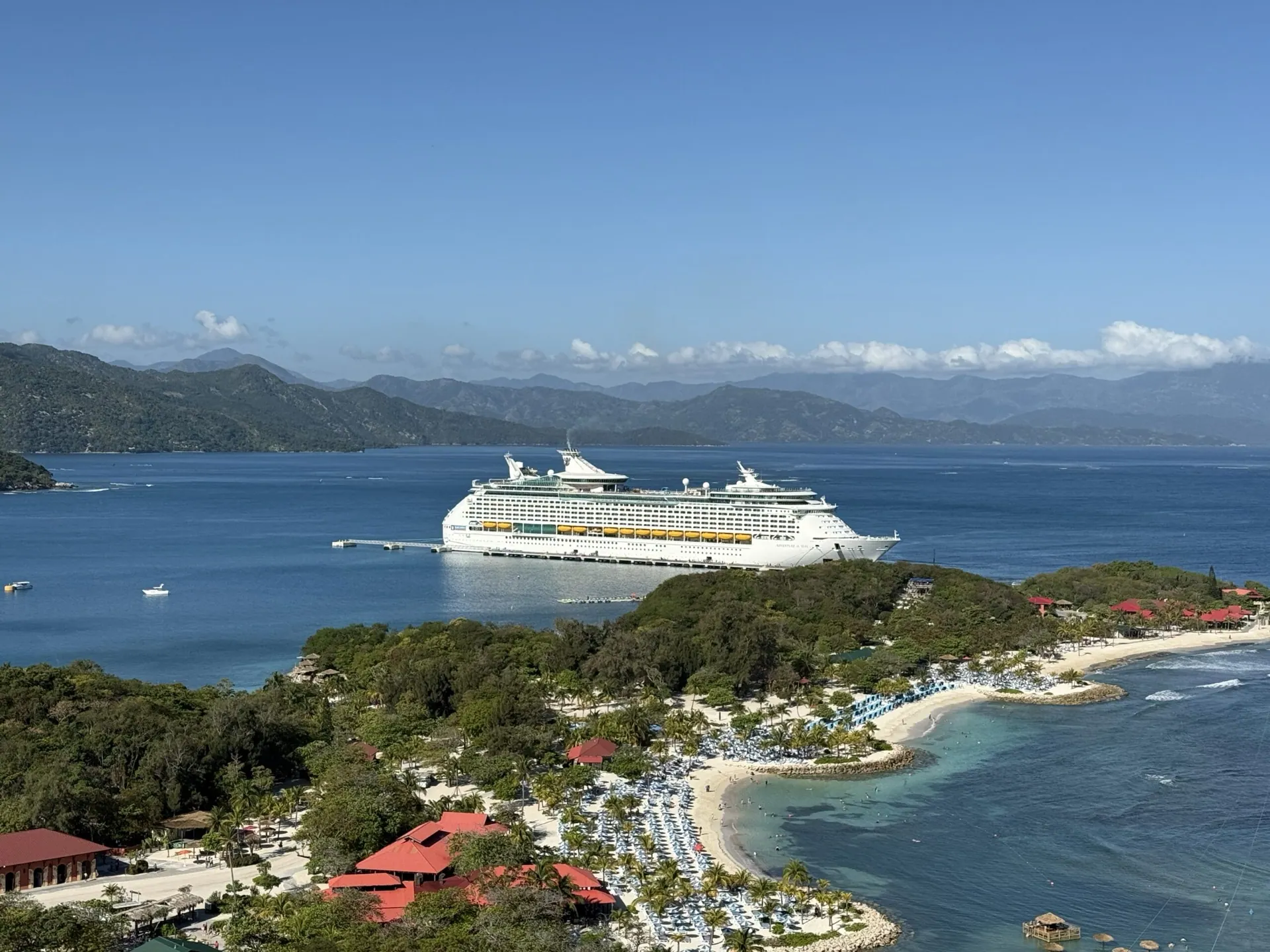 The ship docked in a green island bay