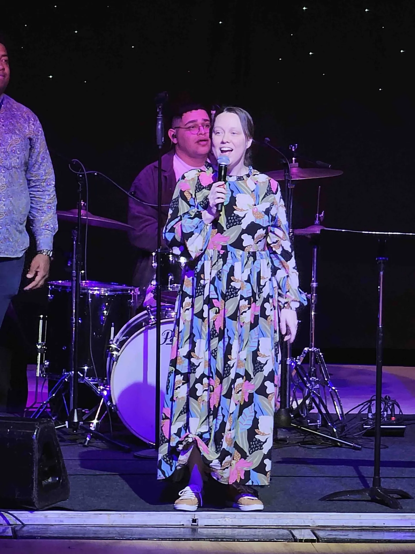 A singer leading worship on stage